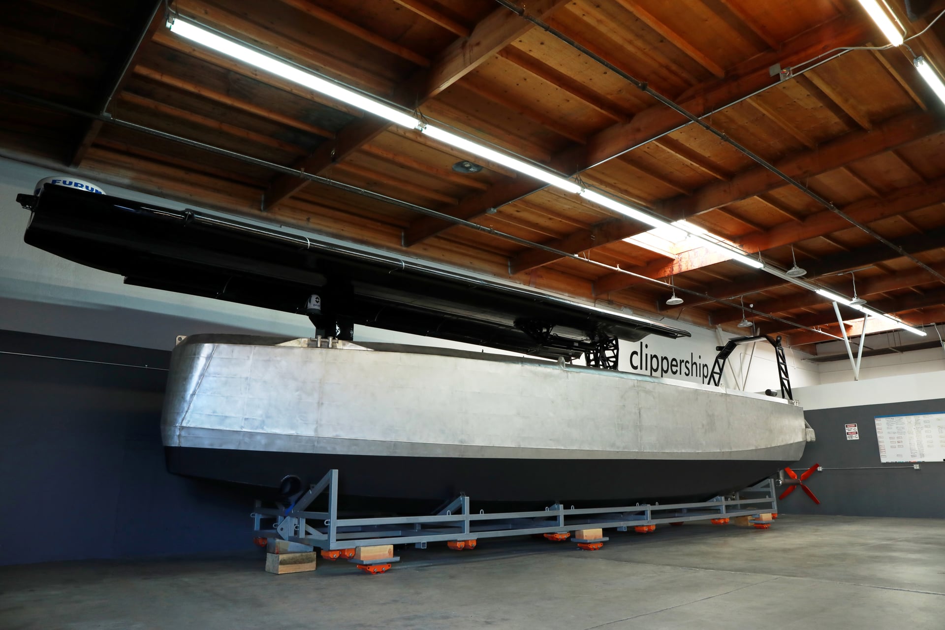 Clippership’s first node with its aluminum hull and folded wing sail in the workshop